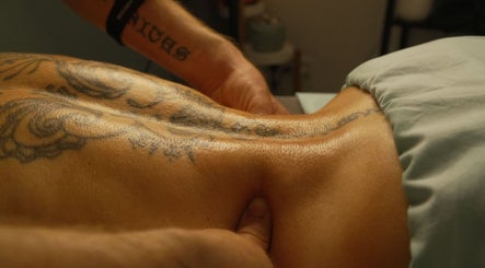 Massage therapy on a tattooed back at Sancti Studio, Nicosia, Nicosia, CY.
