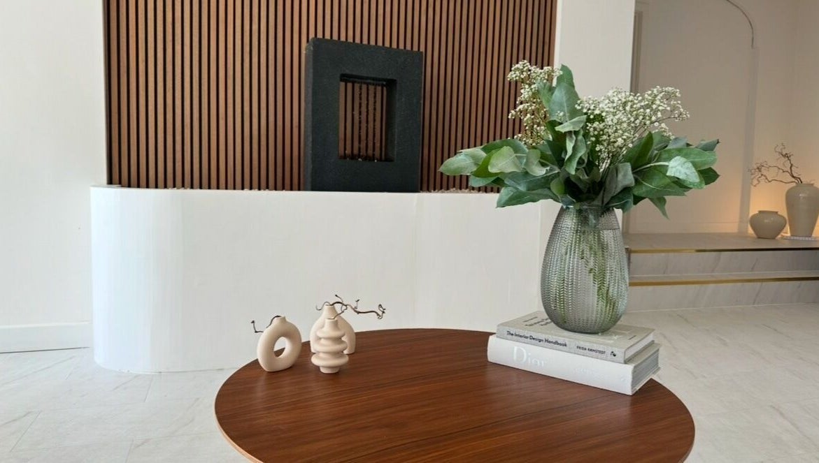 Modern decor and vase on wooden table at Laser and Co, Carlisle, England, GB, offering a tranquil atmosphere.