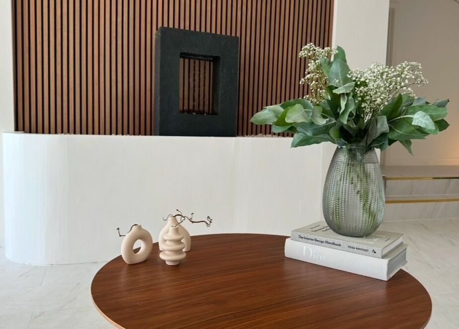 Modern decor and vase on wooden table at Laser and Co, Carlisle, England, GB, offering a tranquil atmosphere.