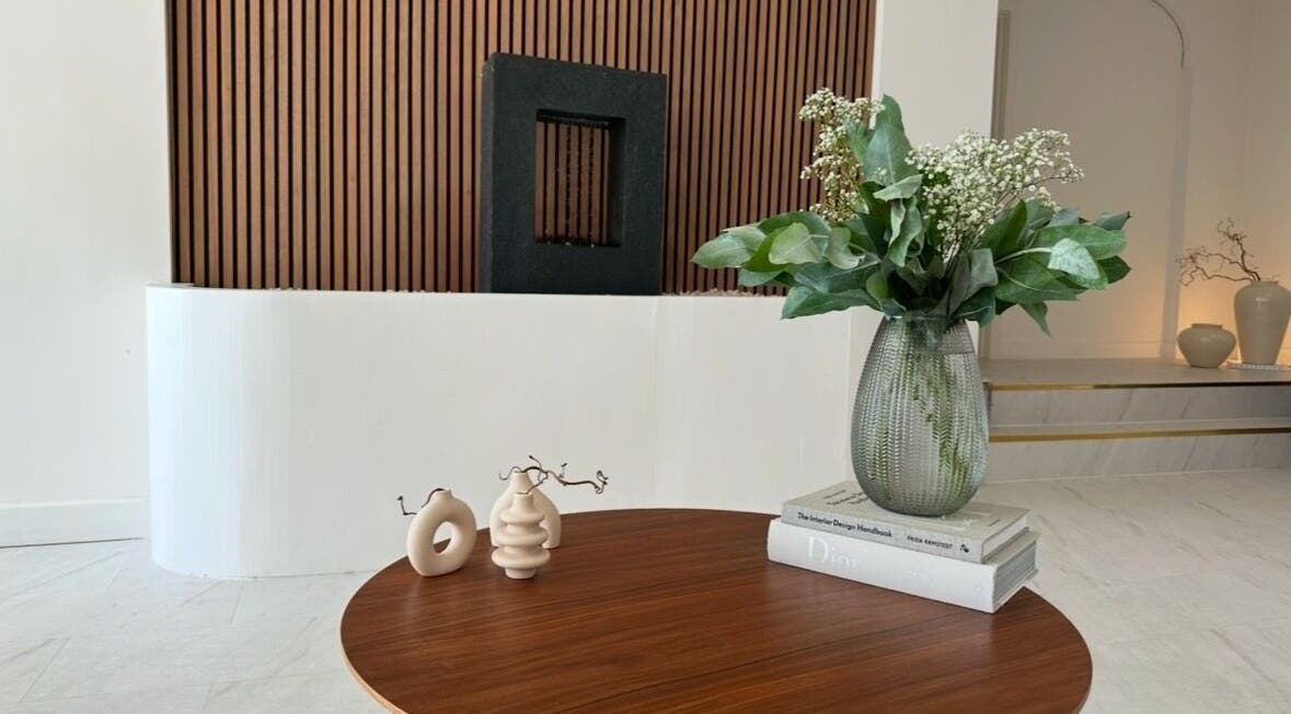 Modern decor and vase on wooden table at Laser and Co, Carlisle, England, GB, offering a tranquil atmosphere.