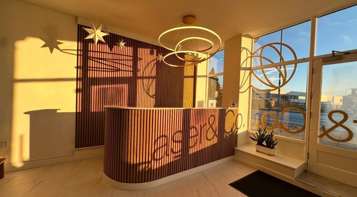 Elegant reception at Laser and Co, Carlisle, England with warm lighting and modern decor.