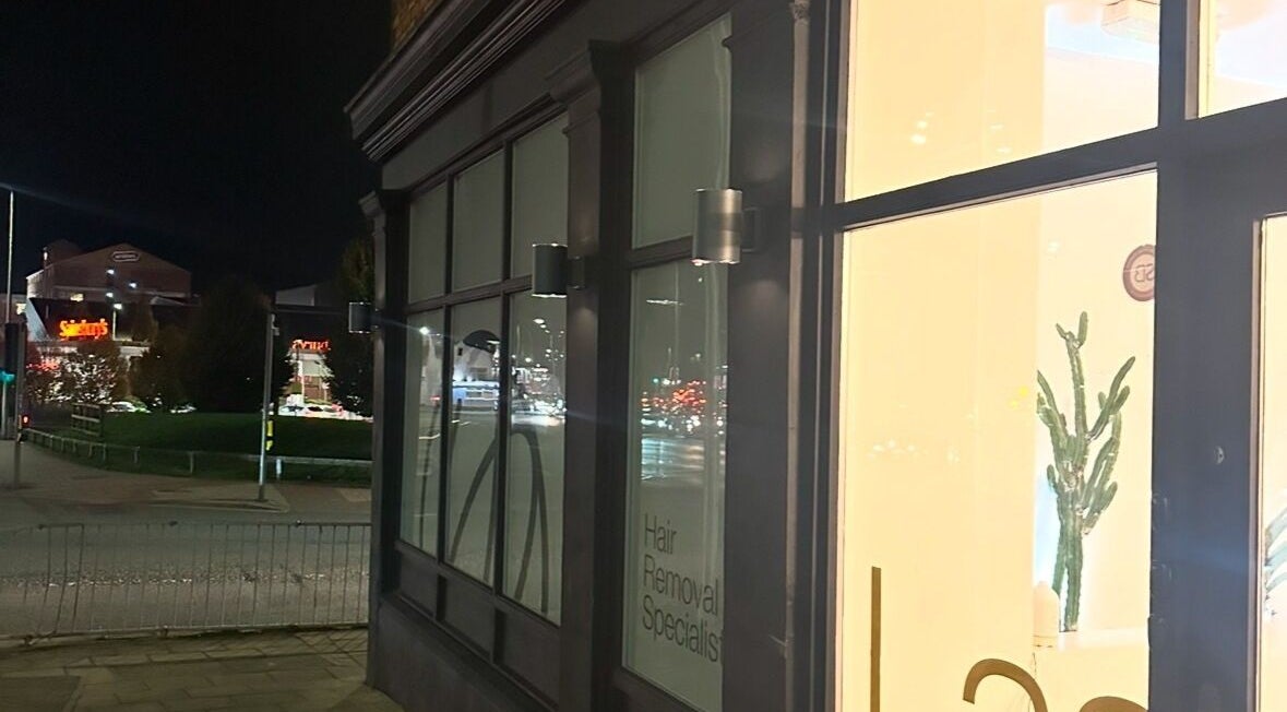 Exterior view of Laser and Co, Carlisle, England, GB under evening lights.