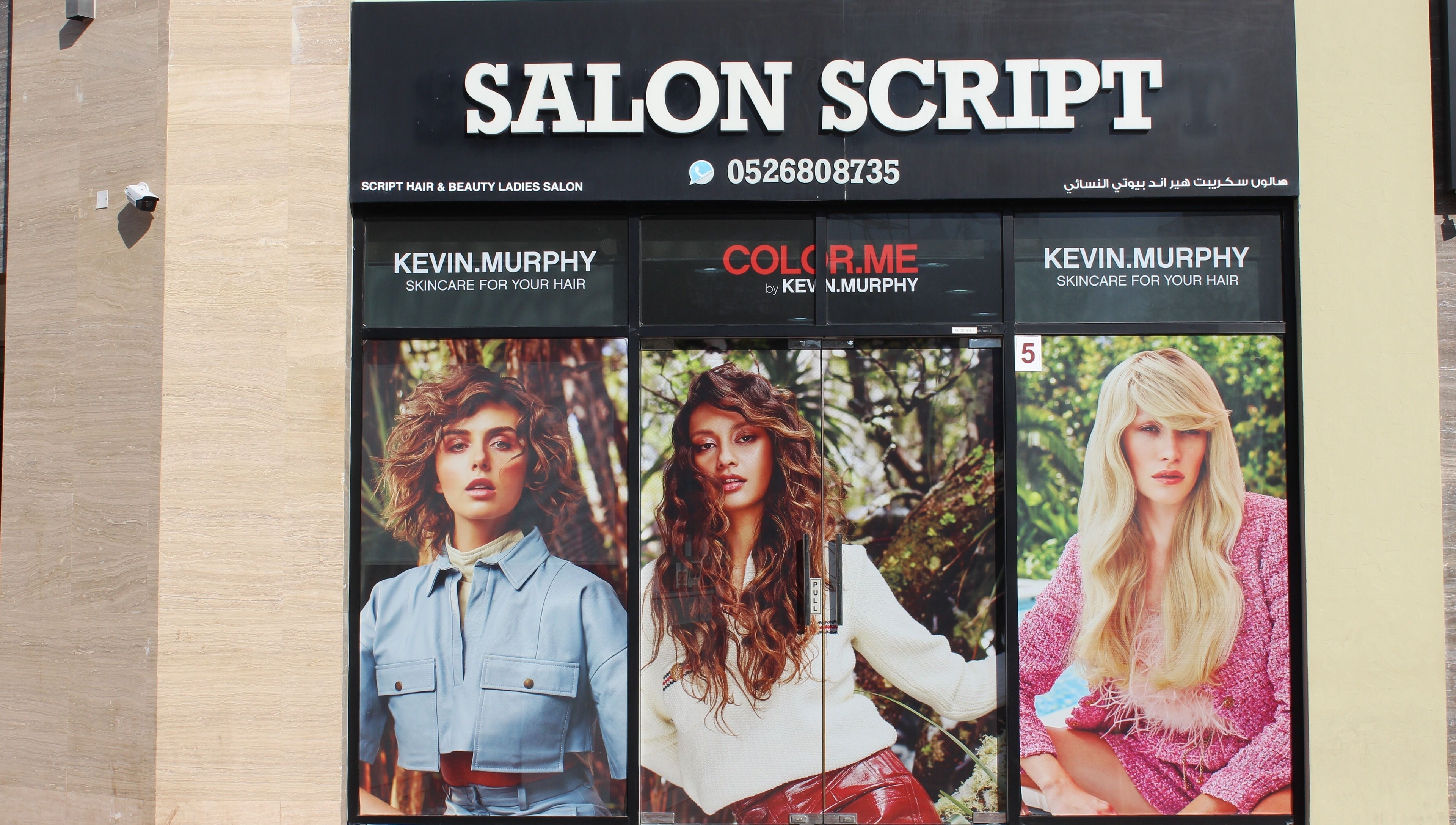 Exterior of Salon Script in Dubai, AE, showcasing vibrant hair models and beauty services.