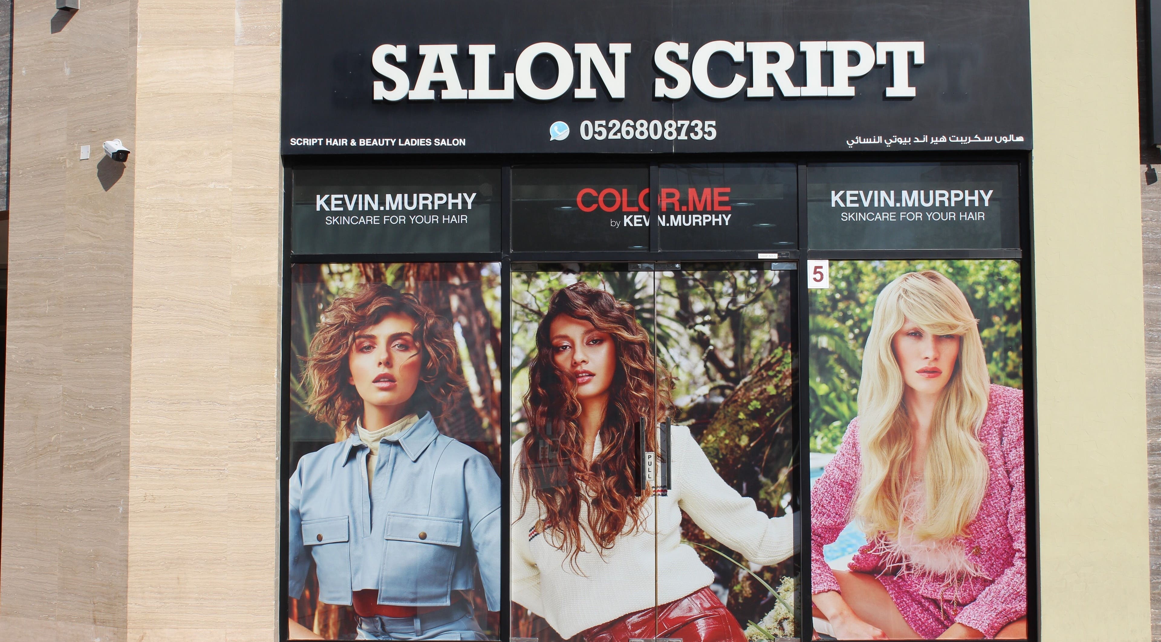 Exterior of Salon Script in Dubai, AE, showcasing vibrant hair models and beauty services.