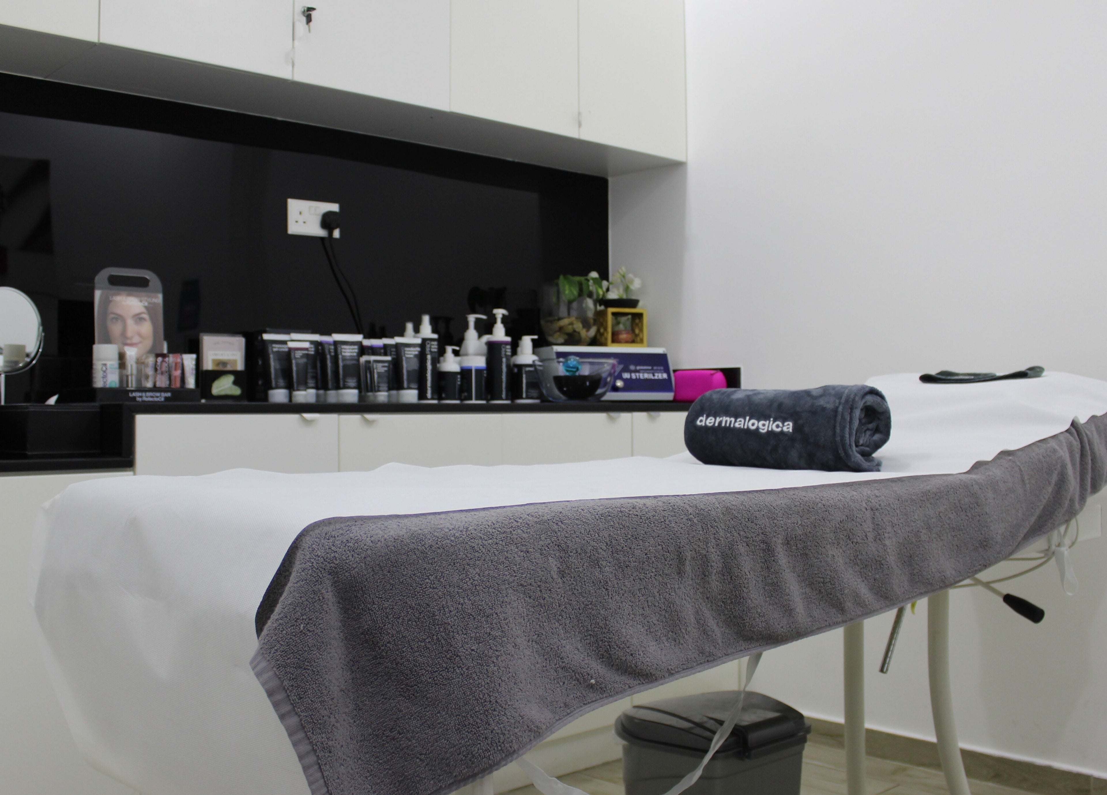 Luxurious treatment room at Salon Script, Dubai, AE showcasing a prepared massage table and skincare products.