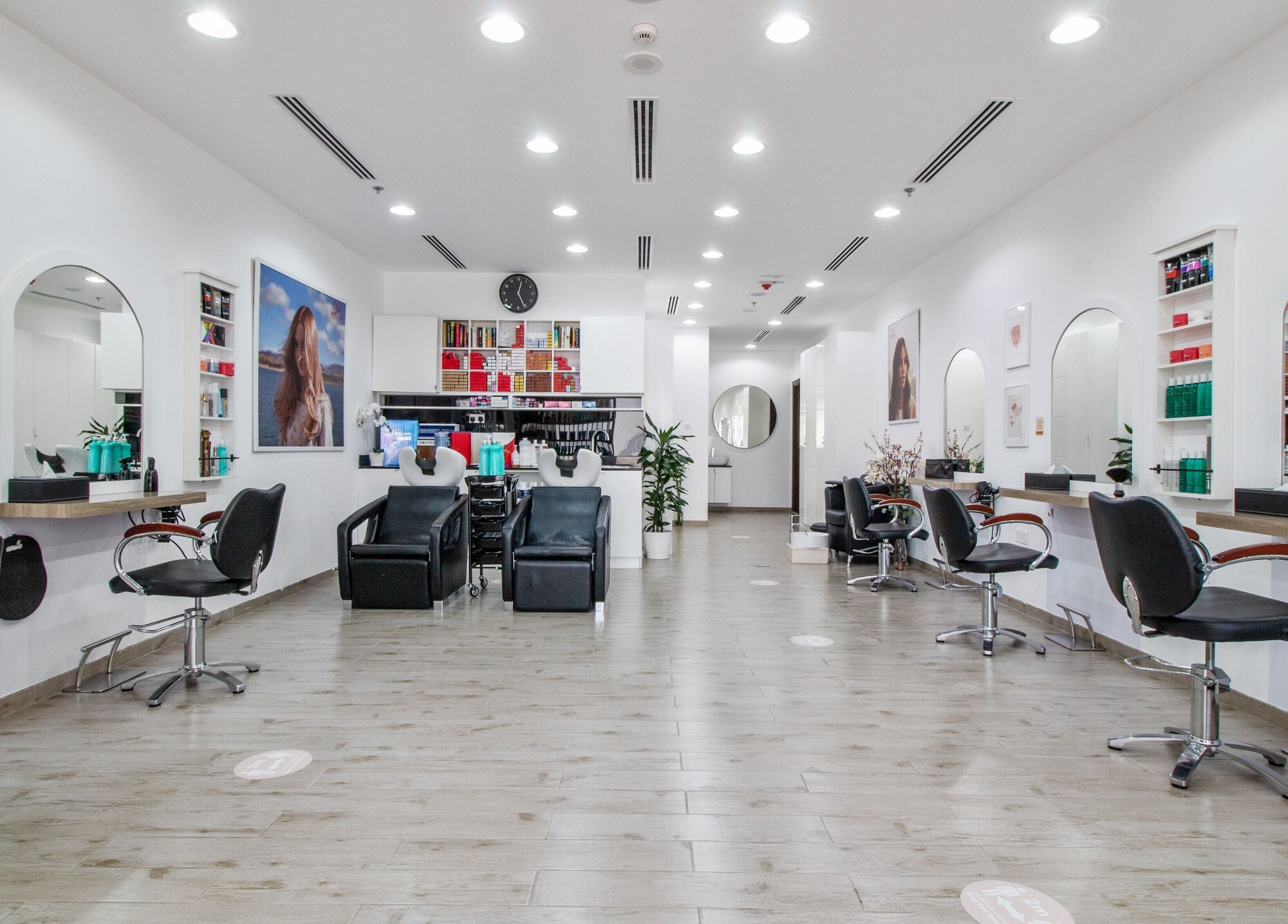 Modern interior of Salon Script in Dubai, AE showcasing sleek styling stations and comfortable seating.