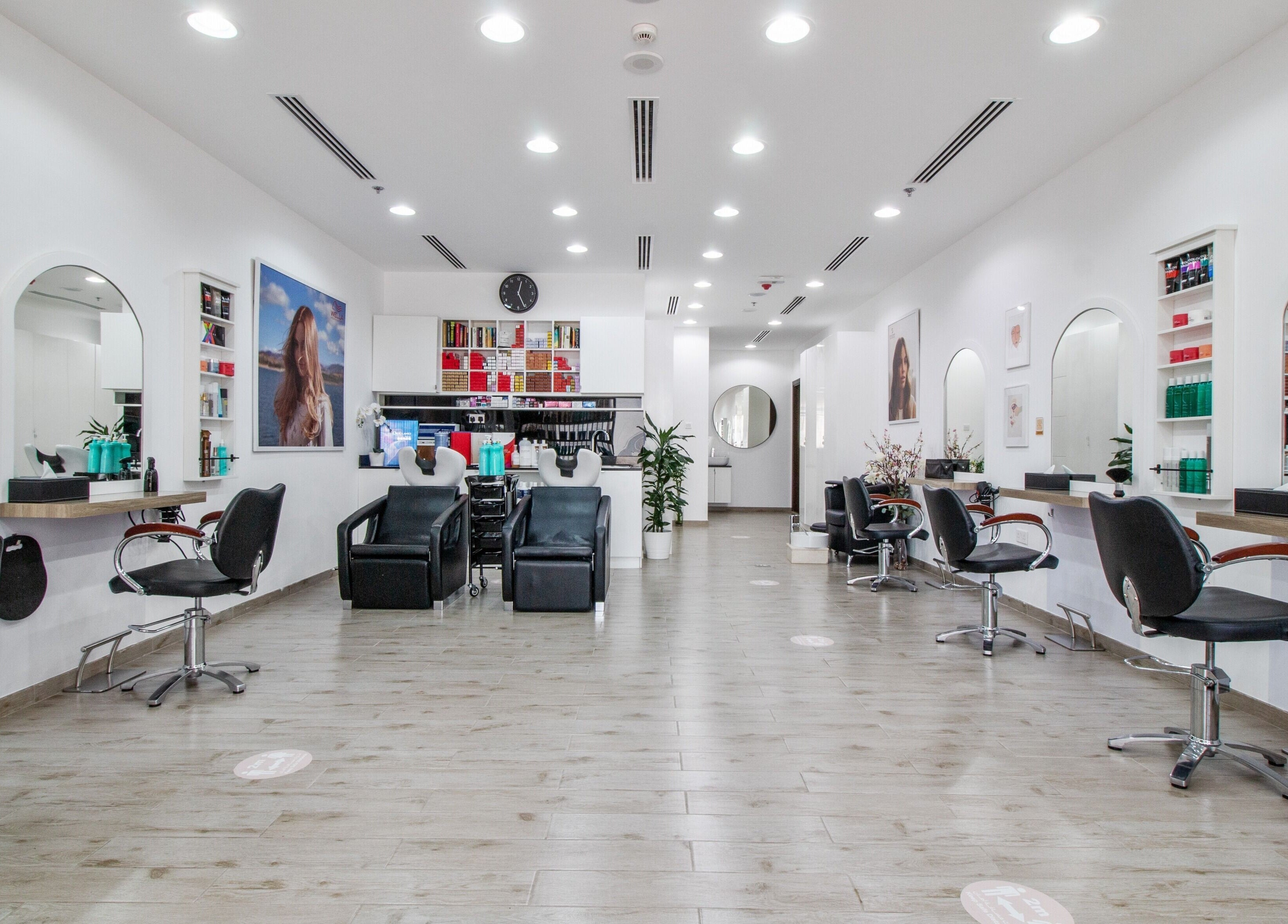 Modern interior of Salon Script in Dubai, AE showcasing sleek styling stations and comfortable seating.