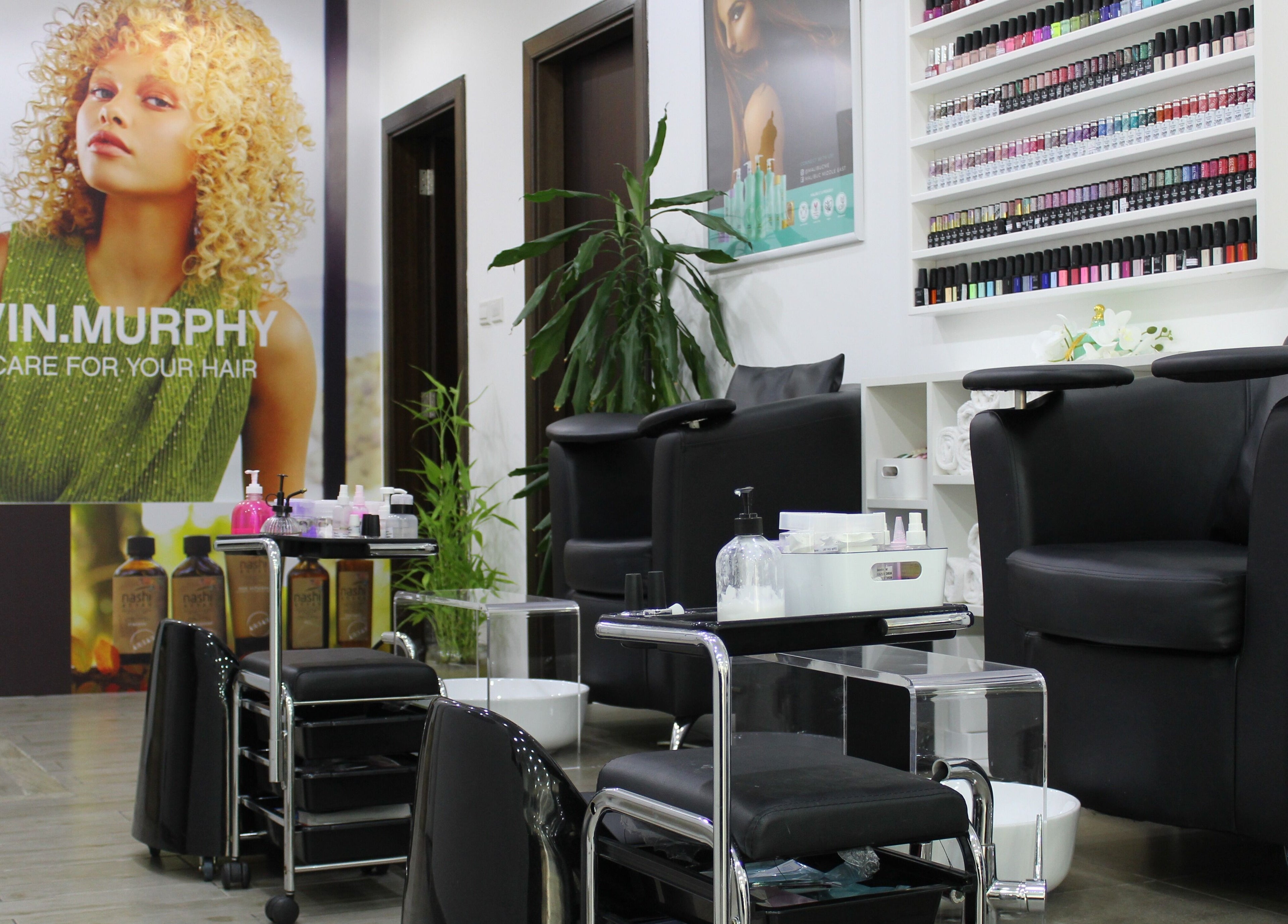 Modern nail salon interior at Salon Script, Dubai, AE with chic decor and extensive nail polish display.