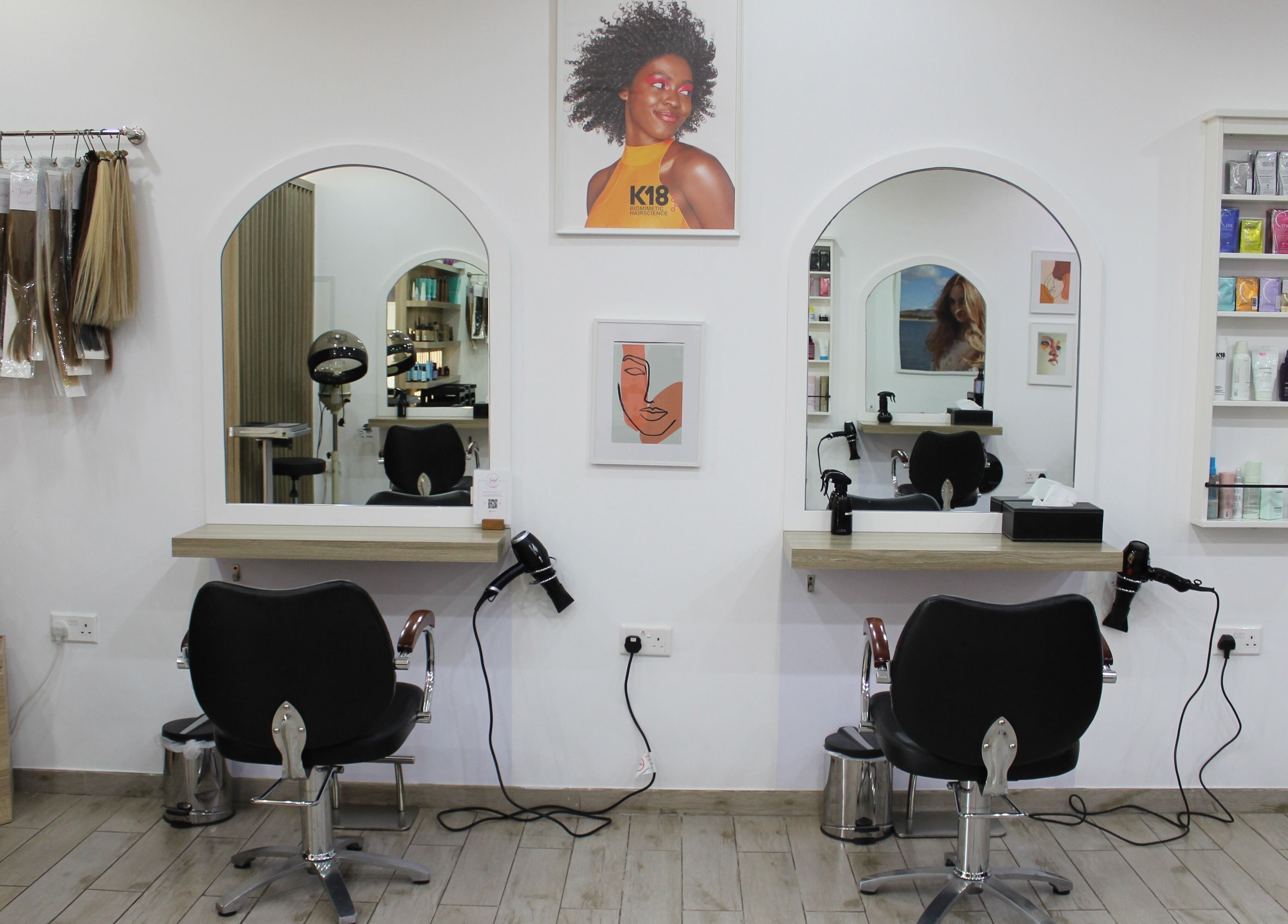 Salon Script's stylish hair styling area in Dubai, AE with professional chairs and mirrors.