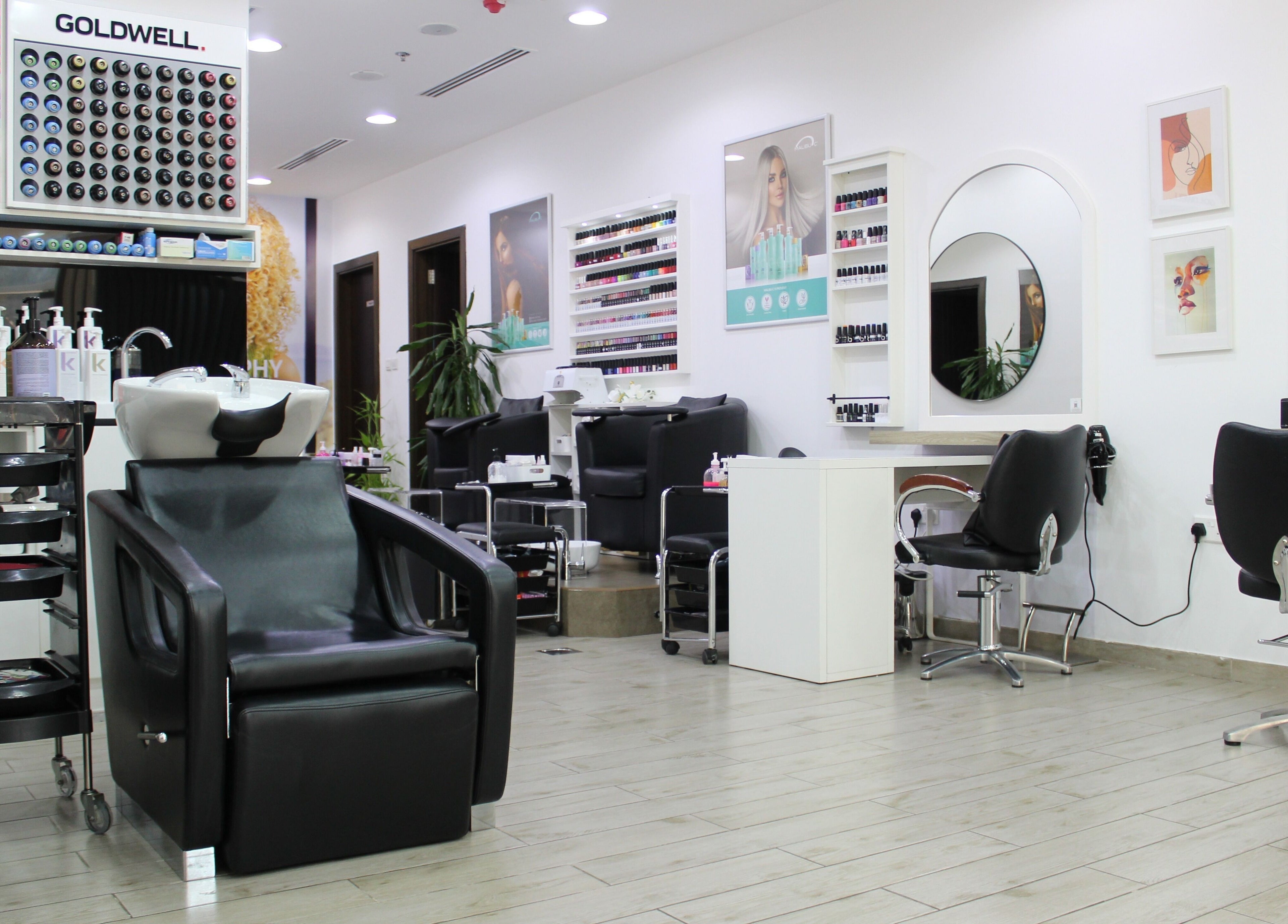 Salon Script in Dubai, AE offers plush chairs and modern salon stations in a stylish setting.