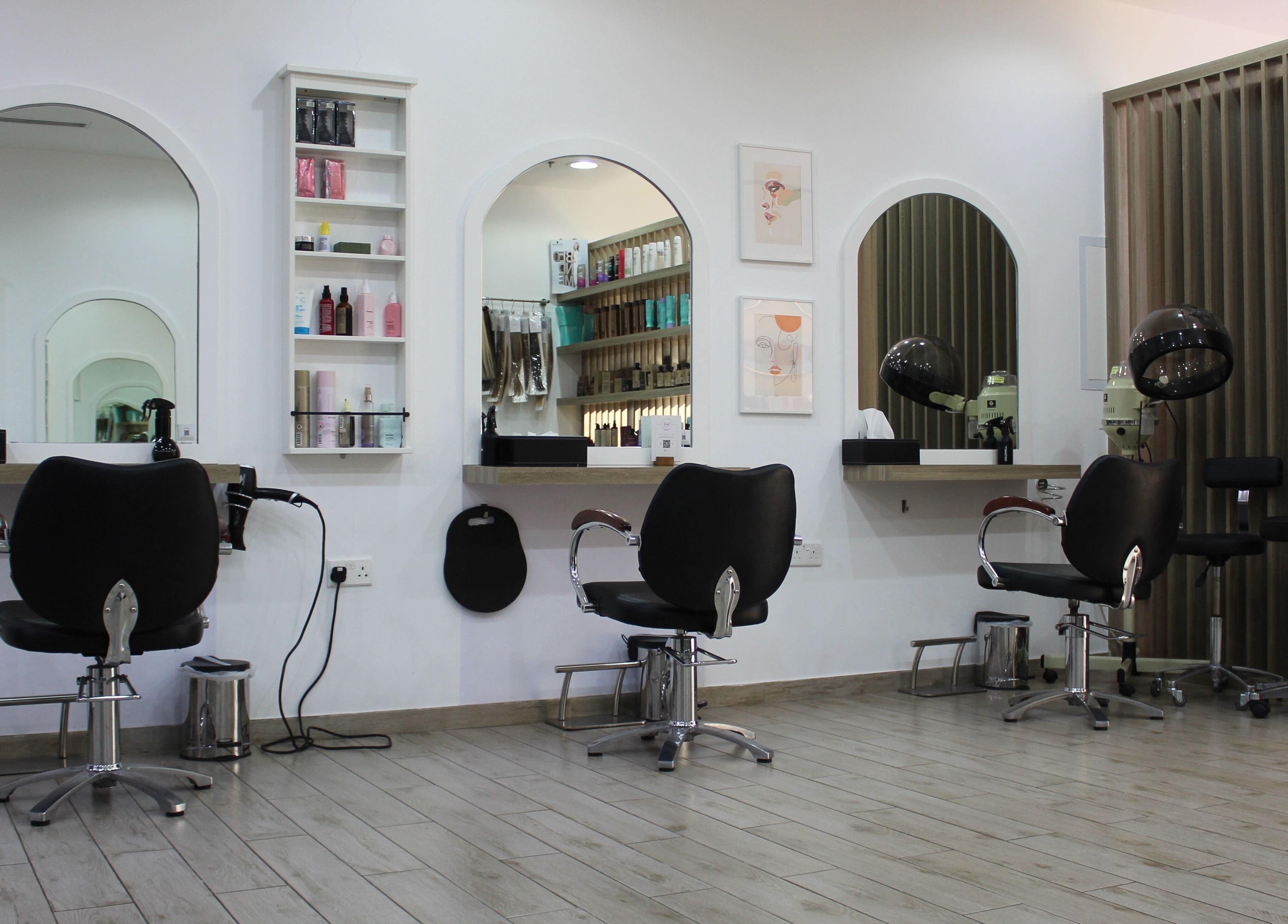 Modern salon interior at Salon Script in Dubai, AE with elegant mirrors and stylist chairs.