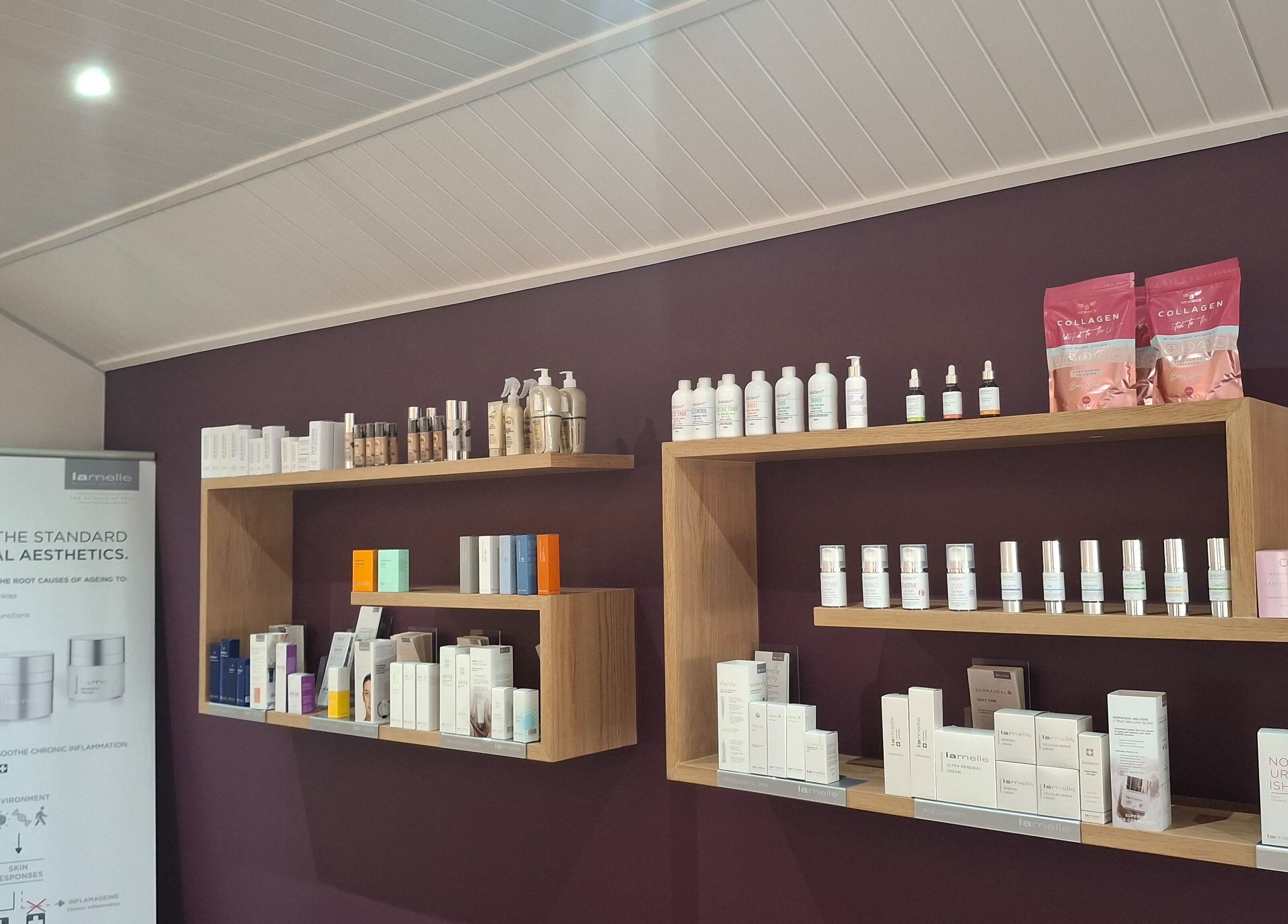 Skincare products on wooden shelves at Go Bare Aesthetics and Skincare Clinic in Wellington, Western Cape, ZA.
