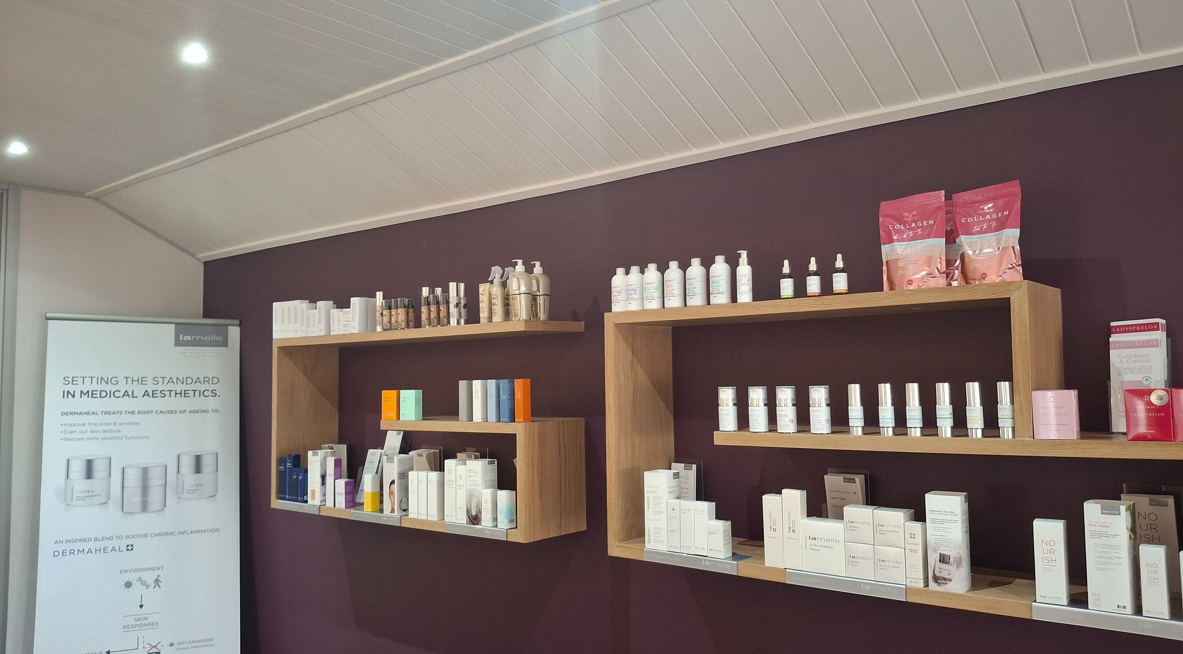 Skincare products on wooden shelves at Go Bare Aesthetics and Skincare Clinic in Wellington, Western Cape, ZA.