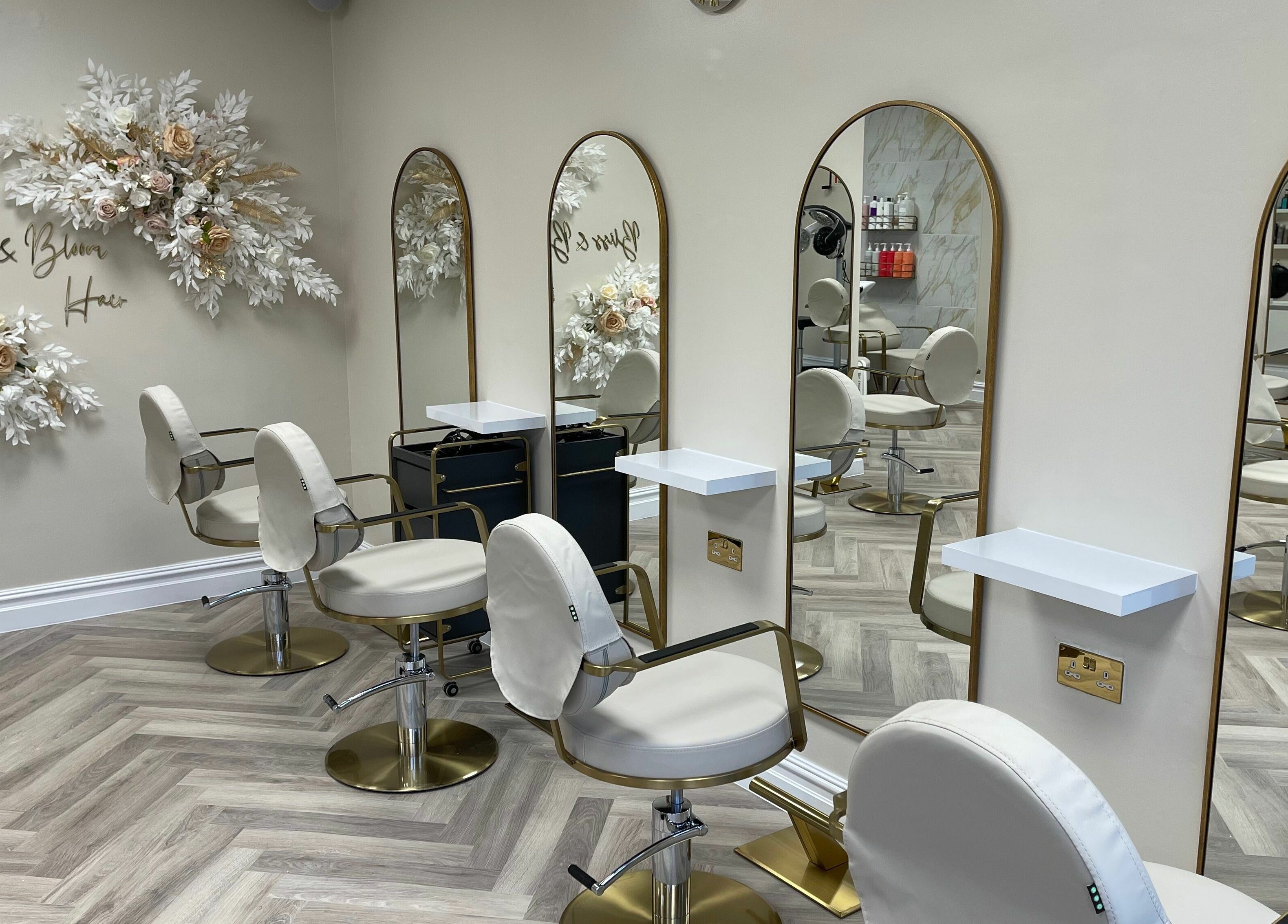 Elegant salon interior at Bliss & Bloom Hair, Nether Poppleton, England, GB, featuring modern chairs and floral decor.