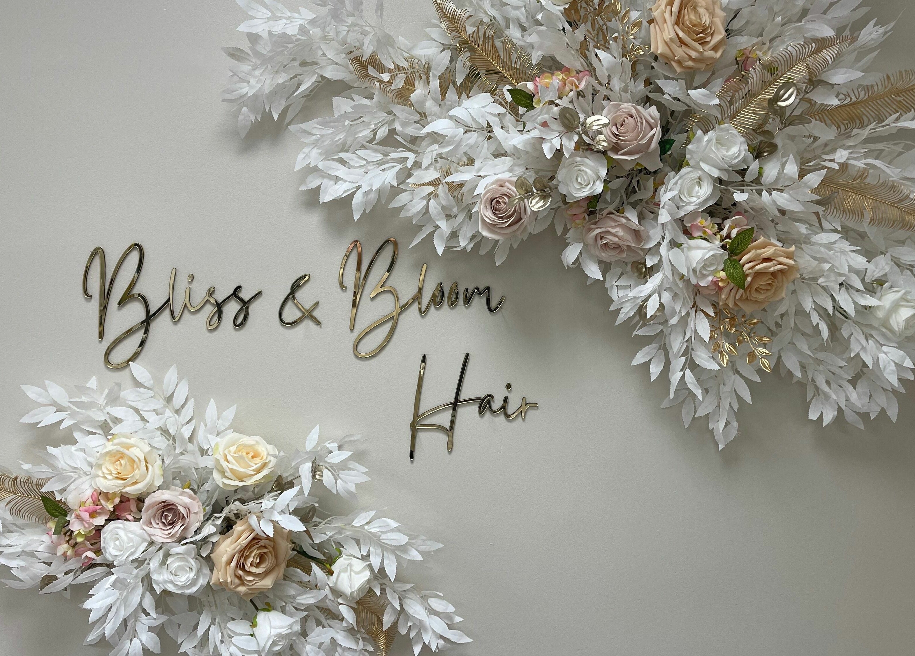 Elegant floral arrangement with 'Bliss & Bloom Hair' sign at Nether Poppleton, England, GB.