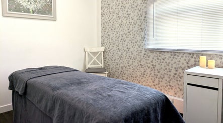 Relaxing massage room at Innerspace Wellbeing, Leicester, England, GB with cozy bed and soft lighting.