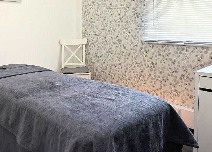Calming treatment room at Innerspace Wellbeing, Leicester, England, GB, with a cozy bed and soothing decor.