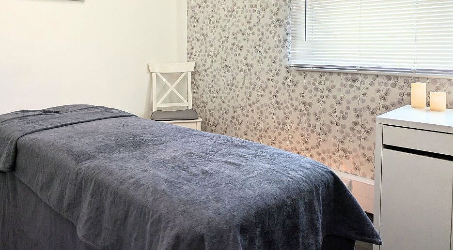 Calming treatment room at Innerspace Wellbeing, Leicester, England, GB, with a cozy bed and soothing decor.