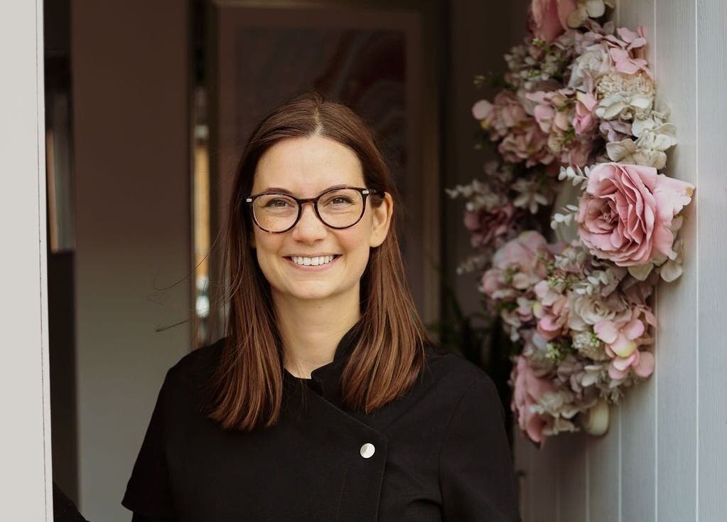 Smiling staff at Innerspace Wellbeing entrance with floral decor, Leicester, England, GB.