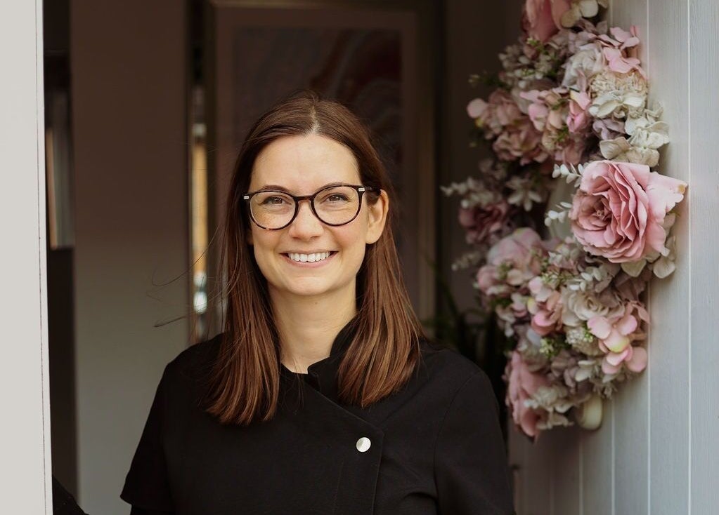 Smiling staff at Innerspace Wellbeing entrance with floral decor, Leicester, England, GB.