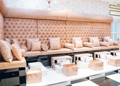 Elegant pedicure seating at Locks by Loulou Al Wasl, Dubai, AE, with plush tufted cushions.