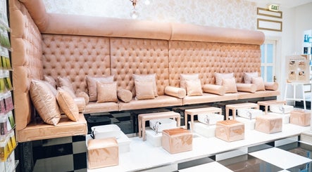 Elegant pedicure seating at Locks by Loulou Al Wasl, Dubai, AE, with plush tufted cushions.