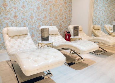 Elegant lounge chairs at Locks by Loulou Al Wasl, Dubai, AE, offering a relaxing beauty experience.