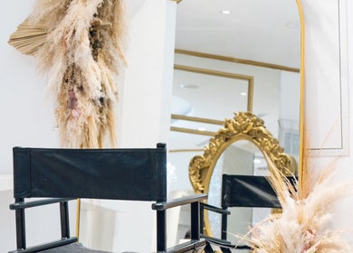 Luxurious styling chair and decor at Locks by Loulou Al Wasl, Dubai, AE with an ornate mirror.