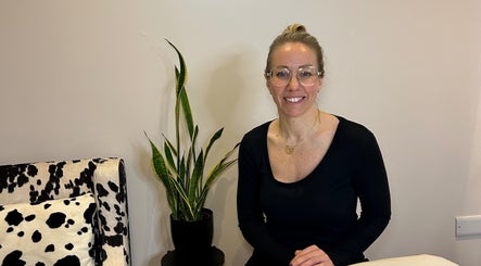 Elegant woman at Sam Jane The Salon, Lostock Hall, England, with plant and stylish decor.