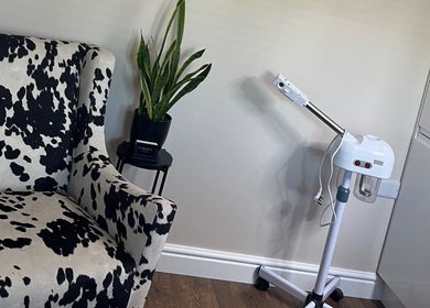 Stylish cow-print chair and steam machine at Sam Jane The Salon, Lostock Hall, England, GB.