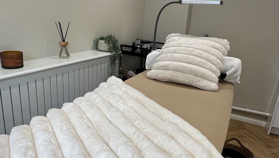 Cozy treatment room at The Beauty Lounge in Thrapston, England, GB with soft white bedding.