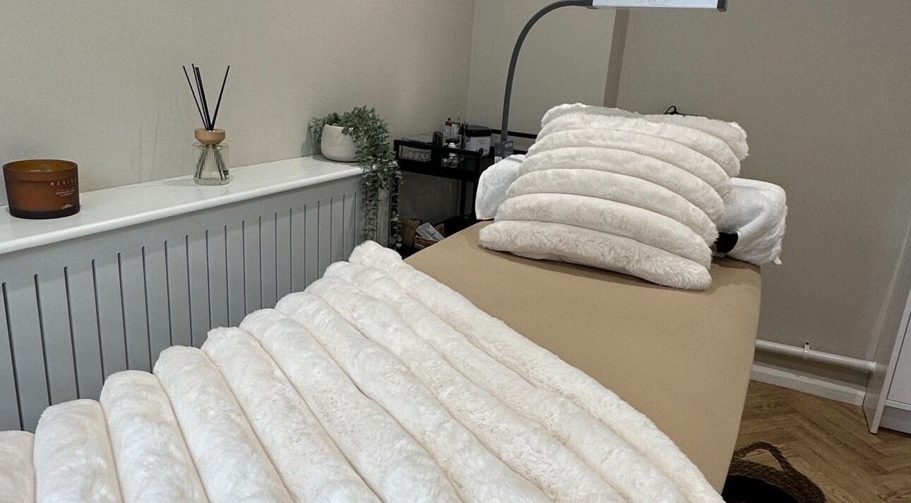 Cozy treatment room at The Beauty Lounge in Thrapston, England, GB with soft white bedding.