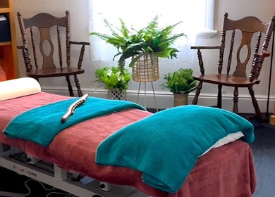Tranquil massage room at Macks Massage in Albany, Western Australia, AU, featuring cozy chairs and greenery.