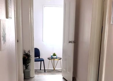 Bright hallway leading to a cozy room at Macks Massage, Albany, Western Australia, AU, featuring elegant decor.