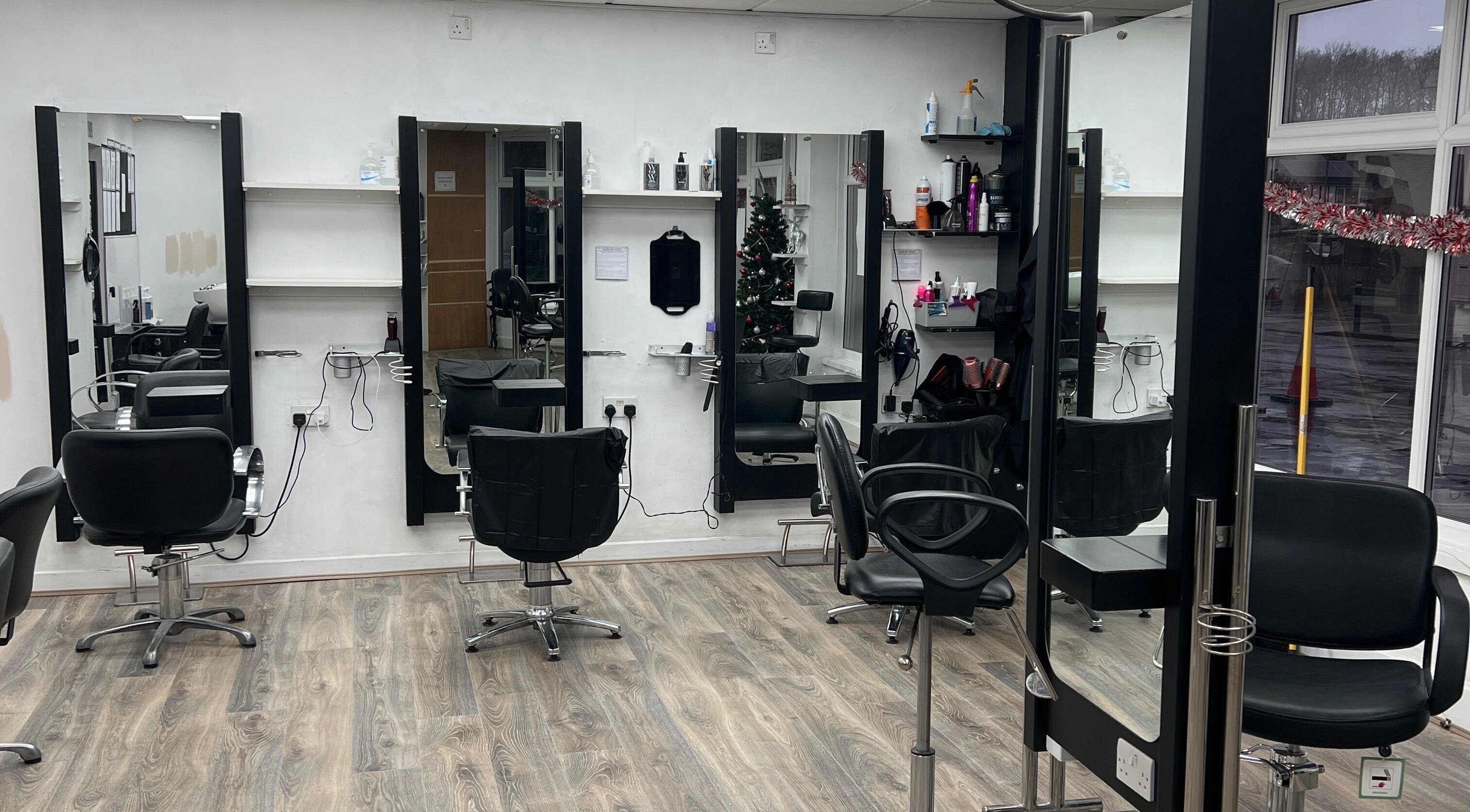 Modern styling stations at Hair By Vicky in Birmingham, England, GB, with sleek chairs and mirrors.