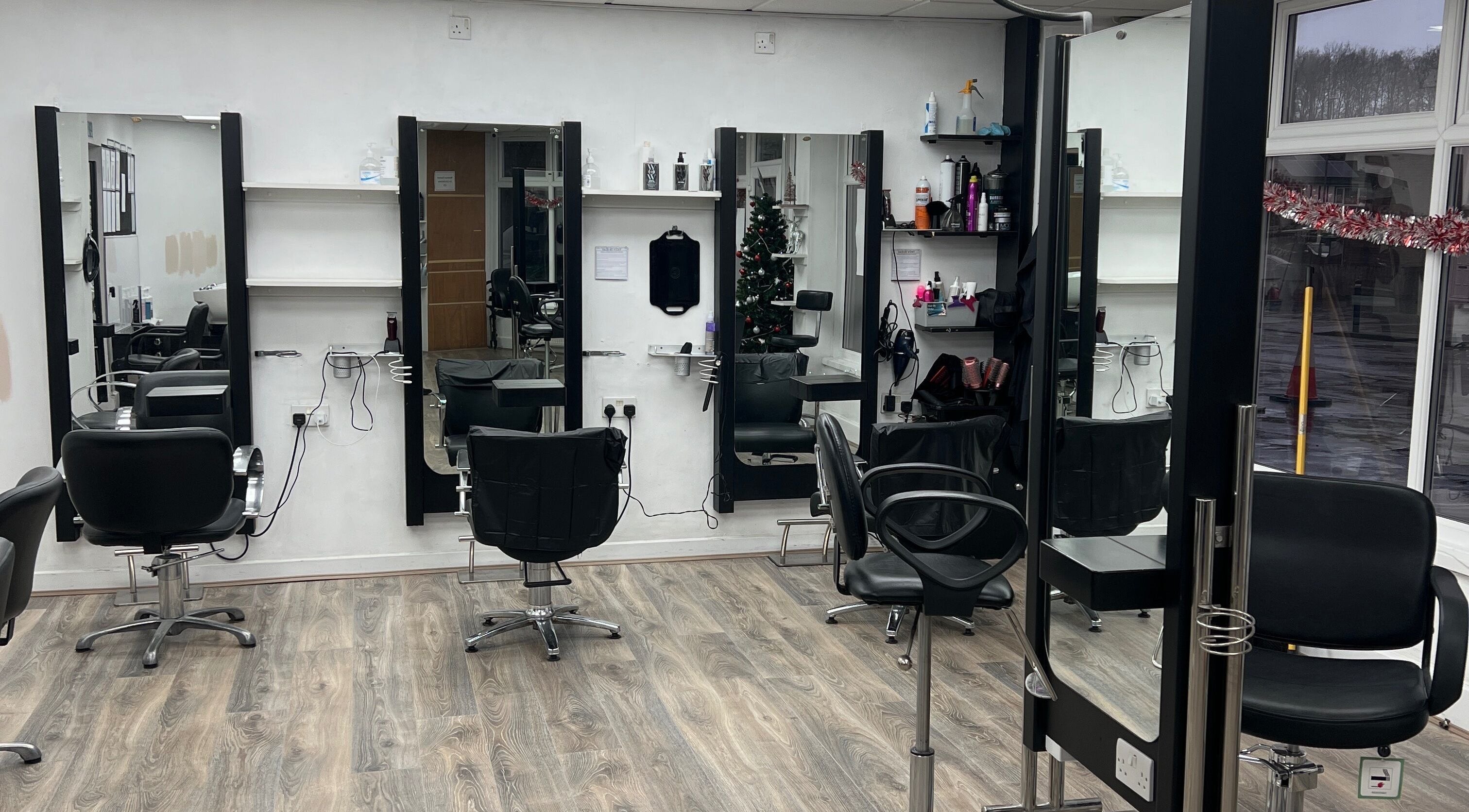 Modern styling stations at Hair By Vicky in Birmingham, England, GB, with sleek chairs and mirrors.