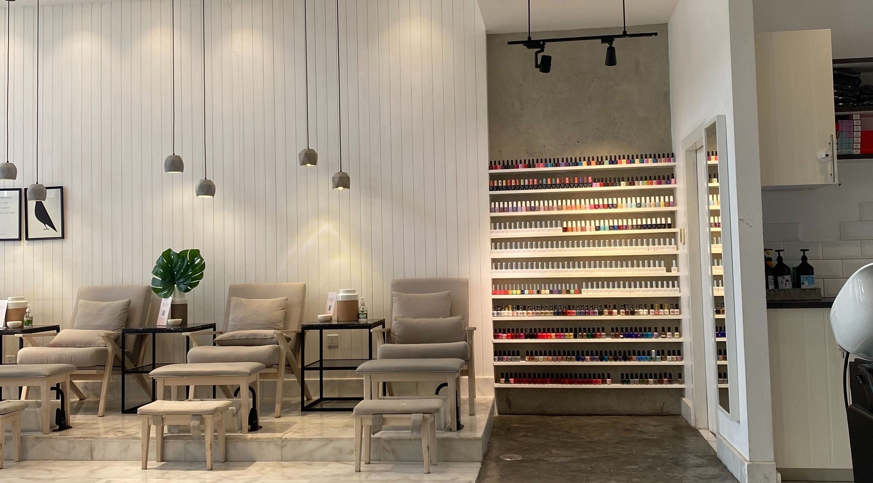 Stylish nail lounge at AURA - Khobar, featuring plush chairs and a vast polish selection. Al Khobar, Eastern Province, SA.