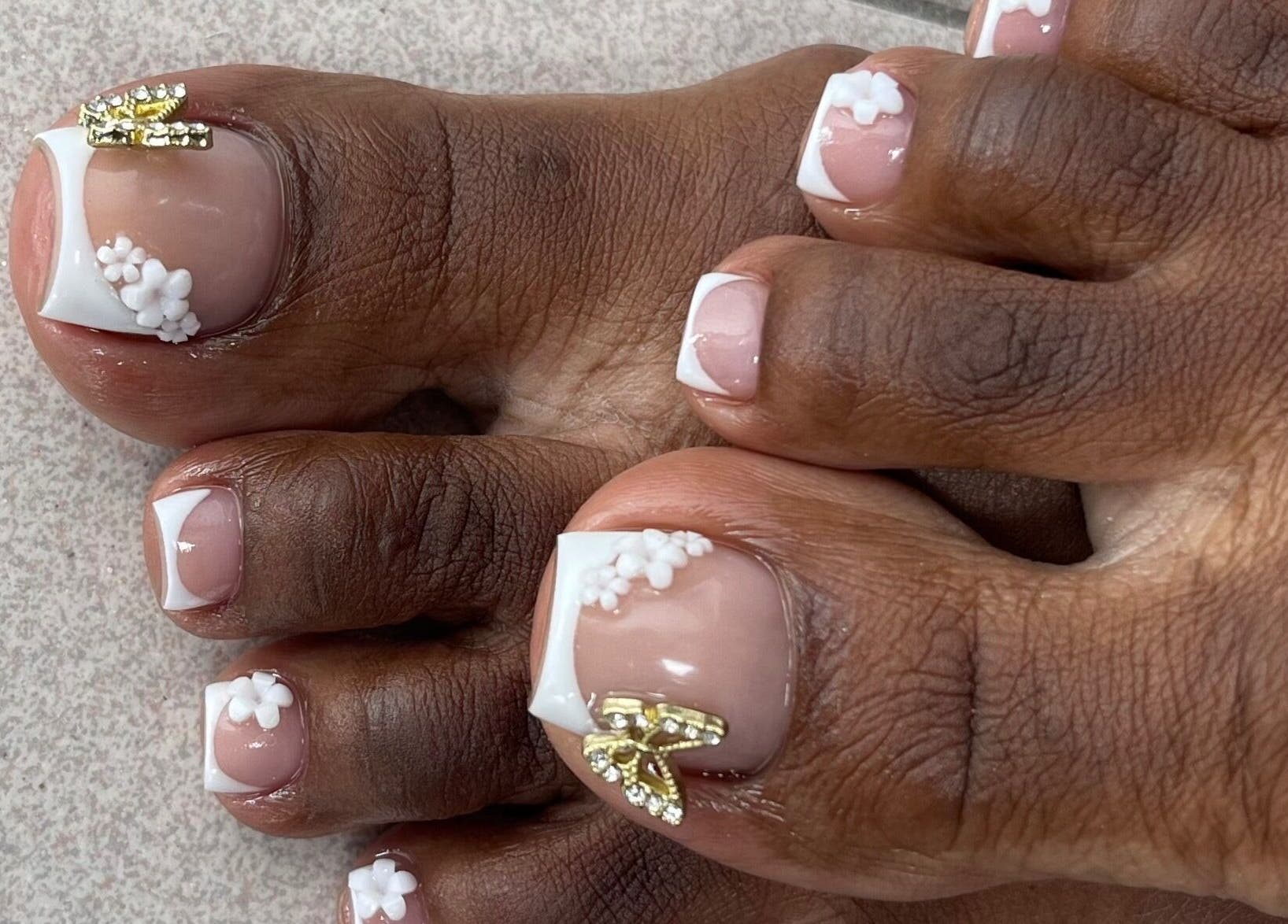 Close-up of floral nail art on toes at SensatioNailz Studio, Bridgetown, Saint Michael, BB.