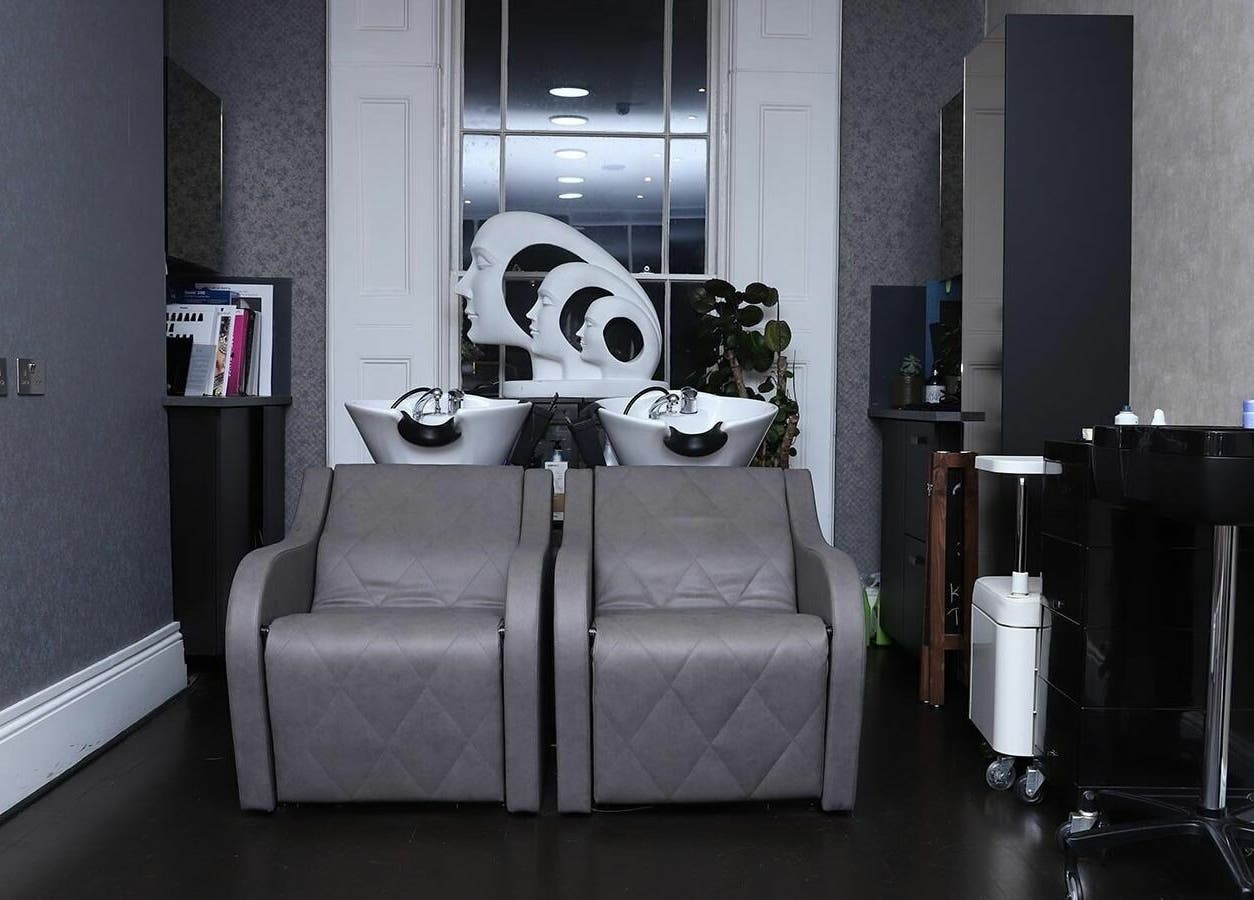 Relaxed wash area at Studio 52 Hair and Beauty, London, England, GB, featuring modern shampoo stations.
