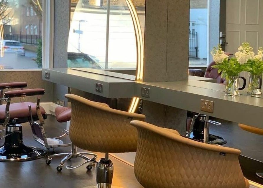 Chic interior of Studio 52 Hair and Beauty, London, England, GB, featuring stylish salon chairs and a large mirror.