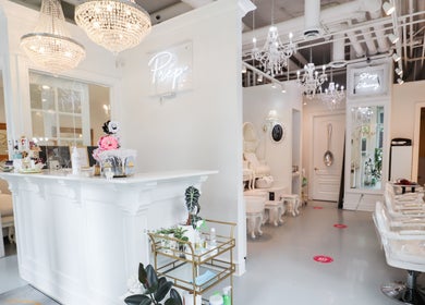 Elegant interior of Prép Beauty Parlour in Vancouver, British Columbia, CA with chandeliers and stylish decor.