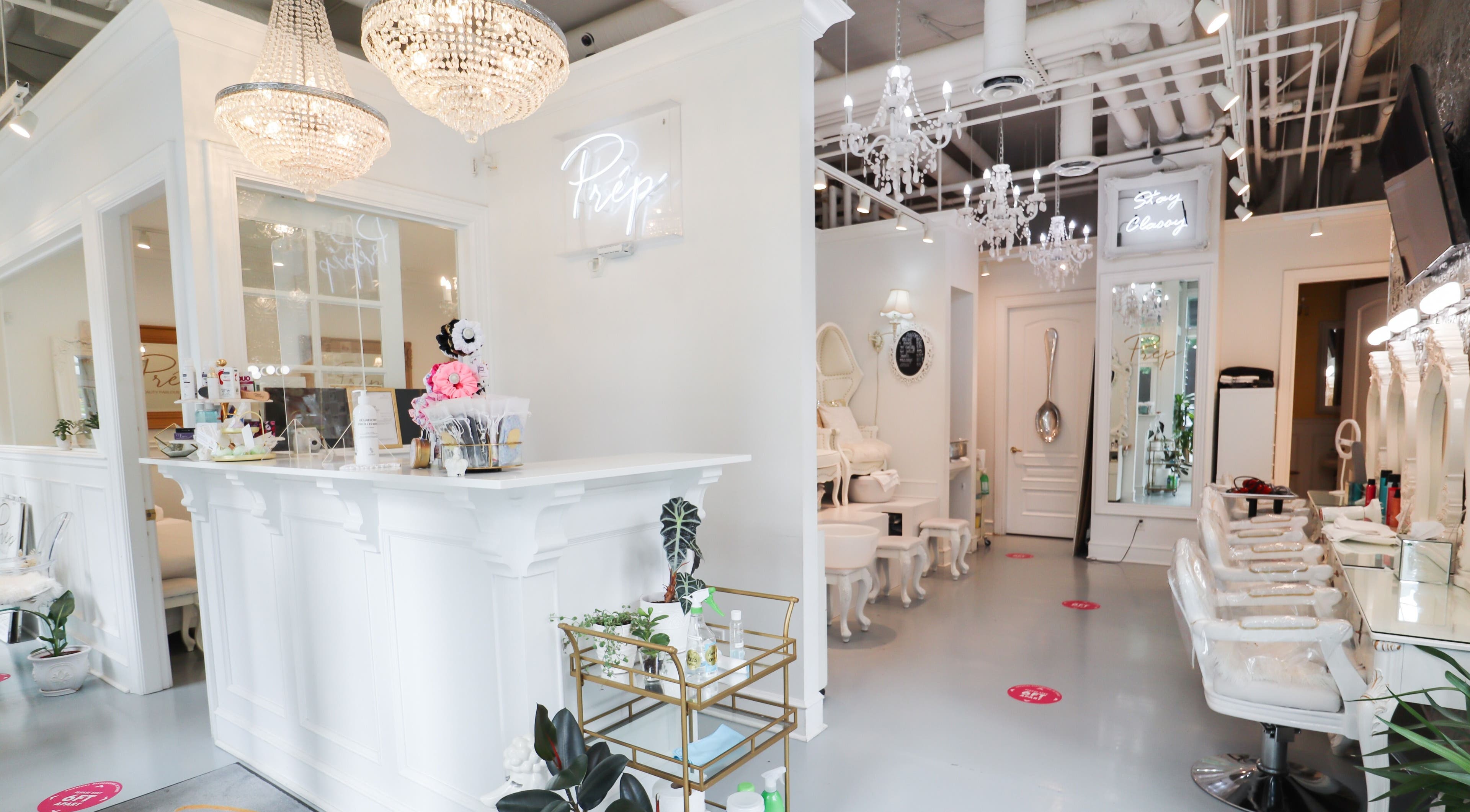 Luxurious interior of Prép Beauty Parlour in Vancouver, British Columbia, CA with chandeliers and chic decor.