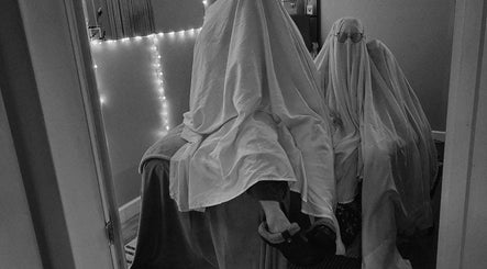 Two figures under sheets in a softly lit room at Braven at Relaxations, Alma, Michigan, US.