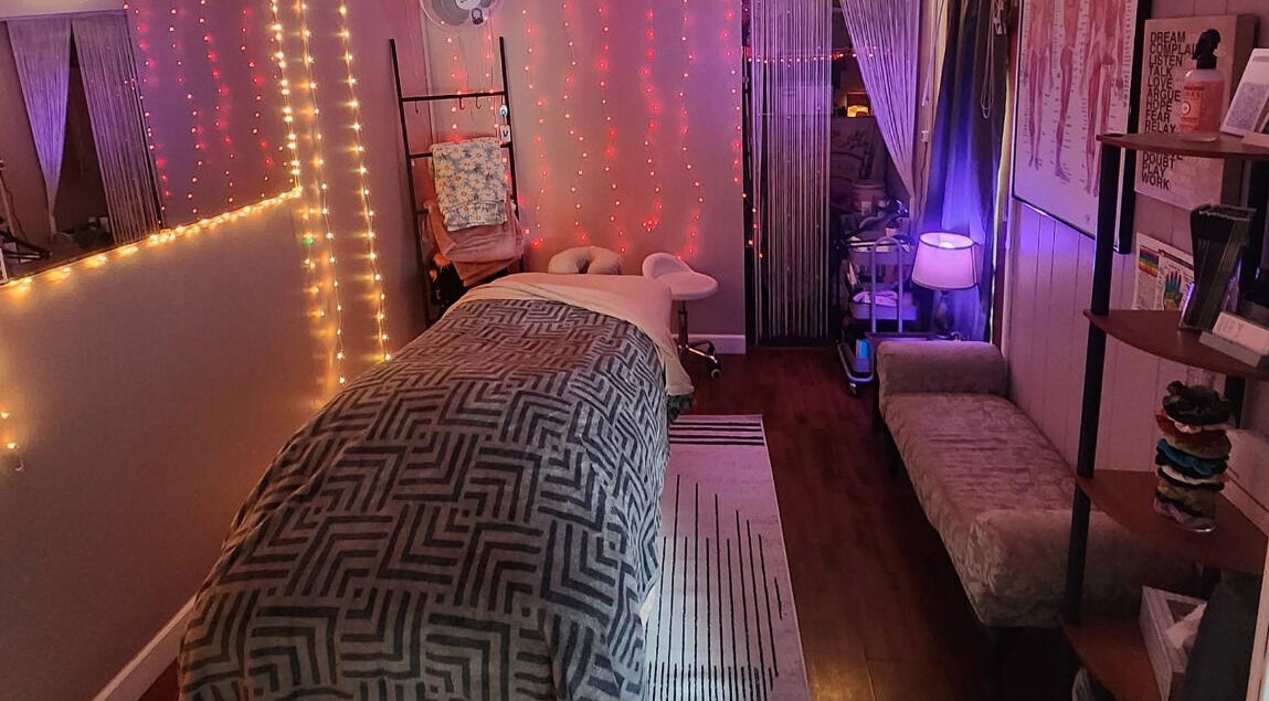 Calming massage room at Braven at Relaxations in Alma, Michigan, US. Cozy ambiance with warm lighting.