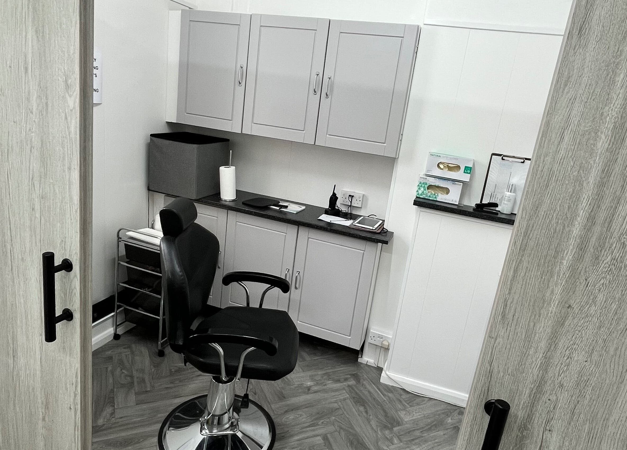 Intimate salon setting at Expressions of Lancaster, Lancaster, England, GB, featuring stylish grey cabinets.
