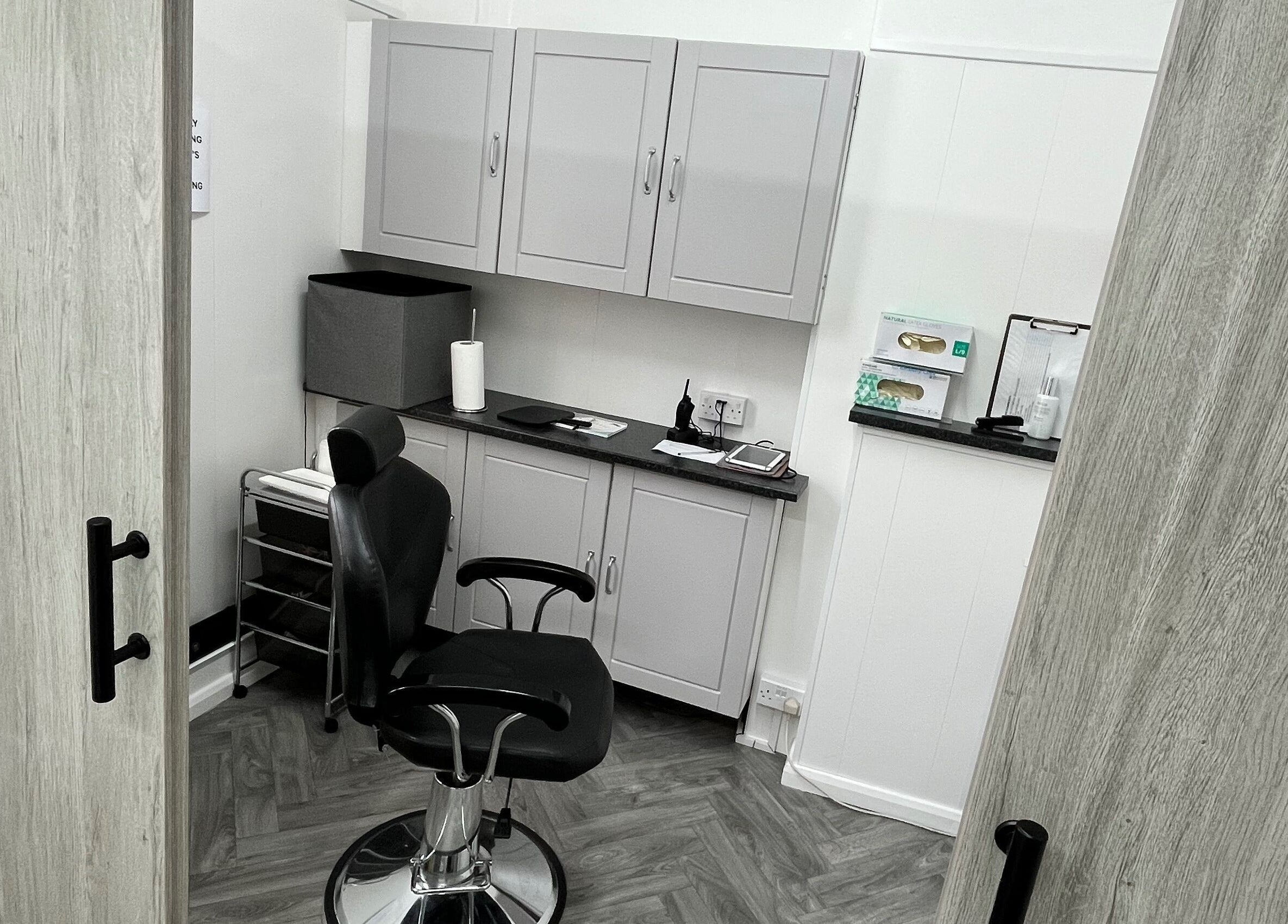 Intimate salon setting at Expressions of Lancaster, Lancaster, England, GB, featuring stylish grey cabinets.