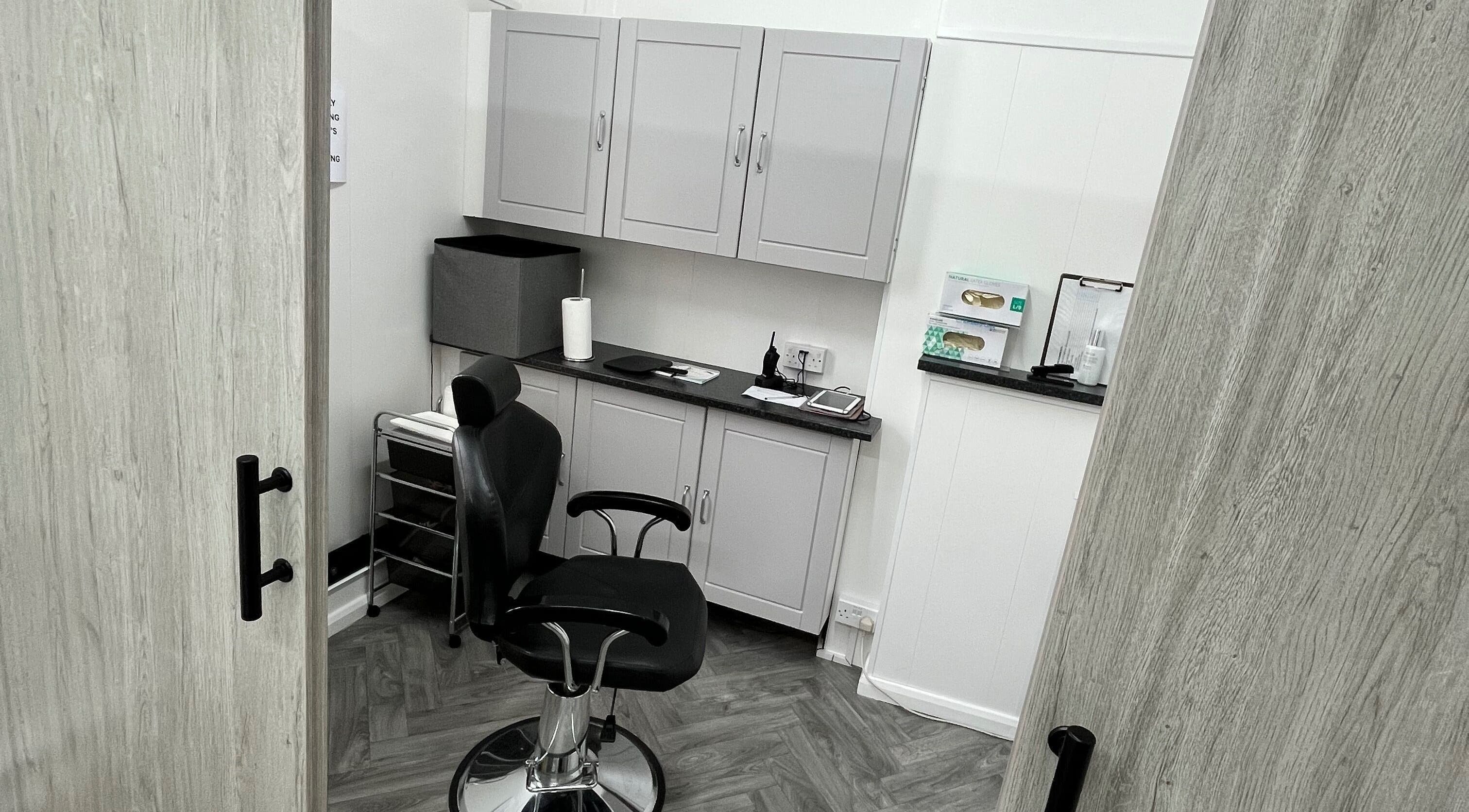 Intimate salon setting at Expressions of Lancaster, Lancaster, England, GB, featuring stylish grey cabinets.