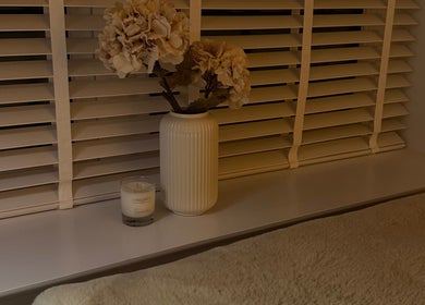 Cozy window setup with flowers and candle at Amber Henman Makeup Artist, Banff, Scotland, GB.