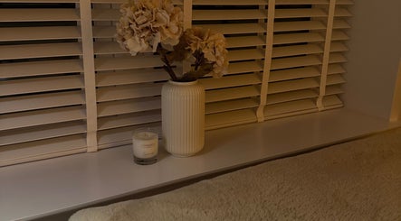 Cozy window setup with flowers and candle at Amber Henman Makeup Artist, Banff, Scotland, GB.