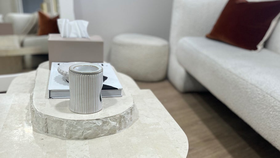 Cozy seating area at Facial Skin Specialist, Smithfield 2164, New South Wales, AU, featuring a stone table and sofas.